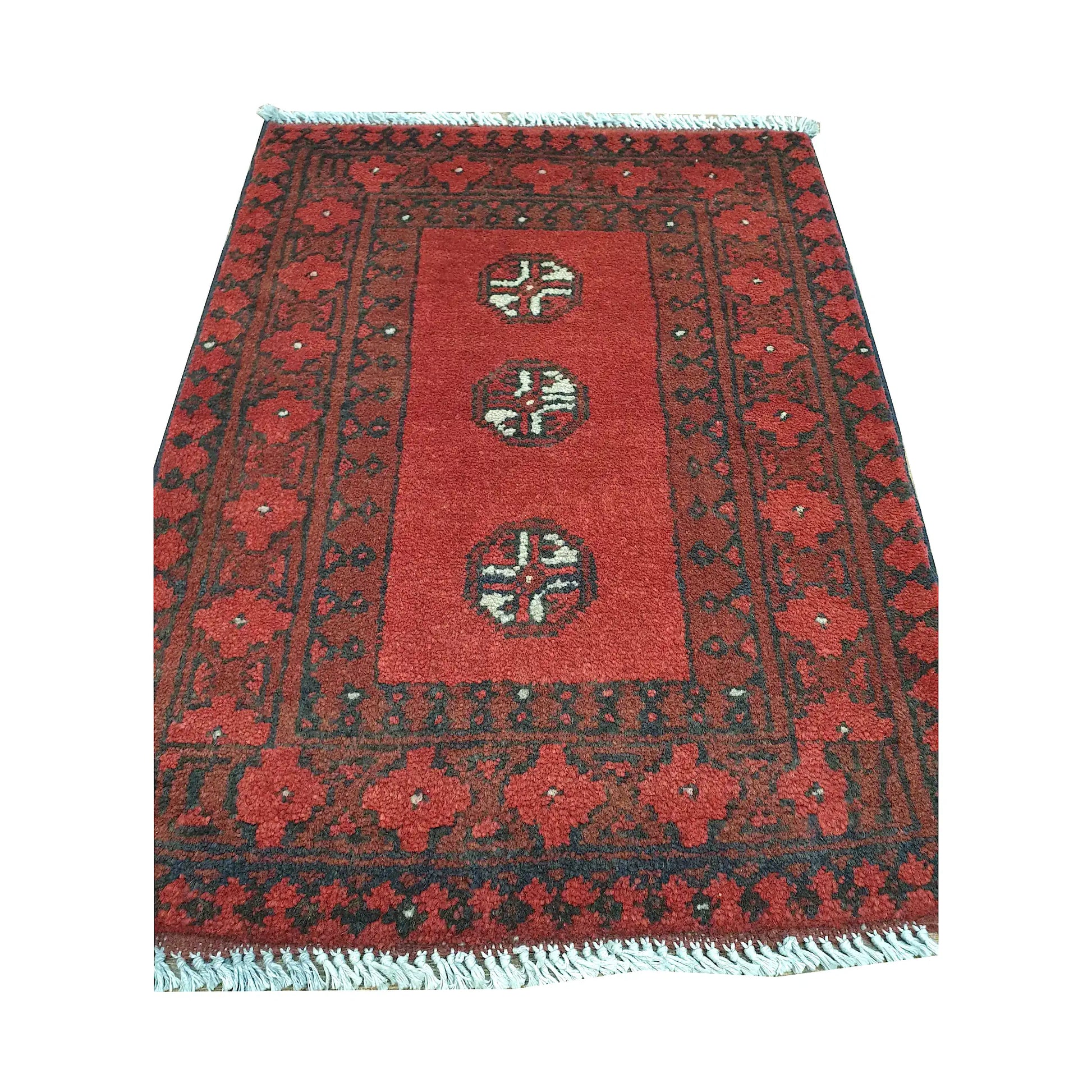 Afghan Turkoman wool rug front detail showing three spaced quartered guls within an open red field