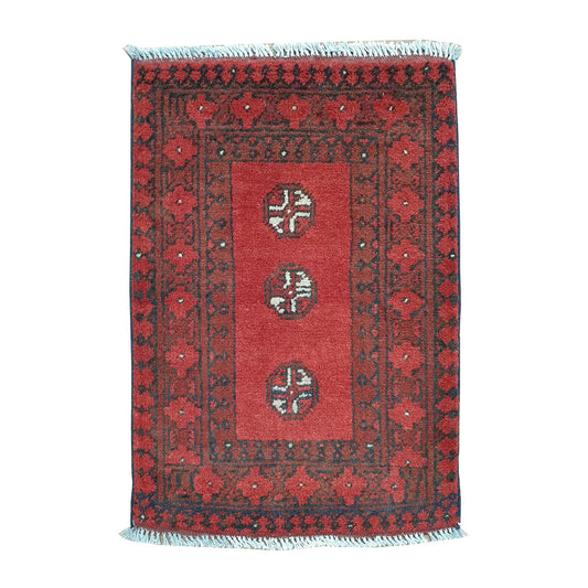 Afghan Turkoman wool rug 70 x 52 cm full view with open red field, three quartered guls and broad tribal borders