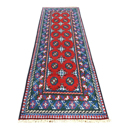Full view of Afghan Turkoman hand-knotted wool runner with deep red field, paired blue gul medallions and multicoloured borders, 249 x 81 cm