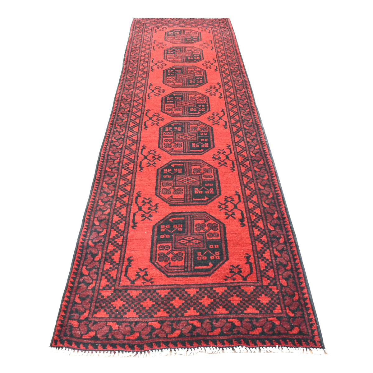 Full view of Afghan Turkoman hand-knotted wool runner with deep red field, stacked dark octagonal guls and geometric borders, 280 x 79 cm