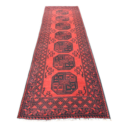 Full view of Afghan Turkoman hand-knotted wool runner with deep red field, stacked dark octagonal guls and geometric borders, 280 x 79 cm