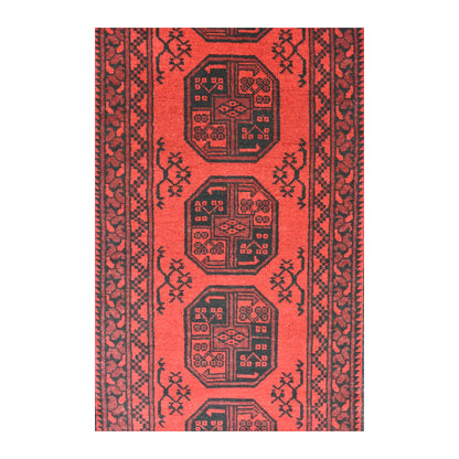 Field detail of Afghan Turkoman wool runner showing stacked compartmented guls across an open red field