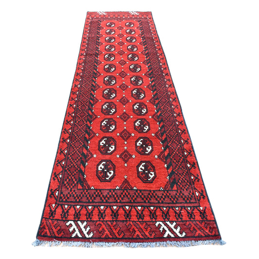 Full view of Afghan Turkoman hand-knotted wool runner with deep red field, paired oval guls and dark geometric borders, 283 x 79 cm