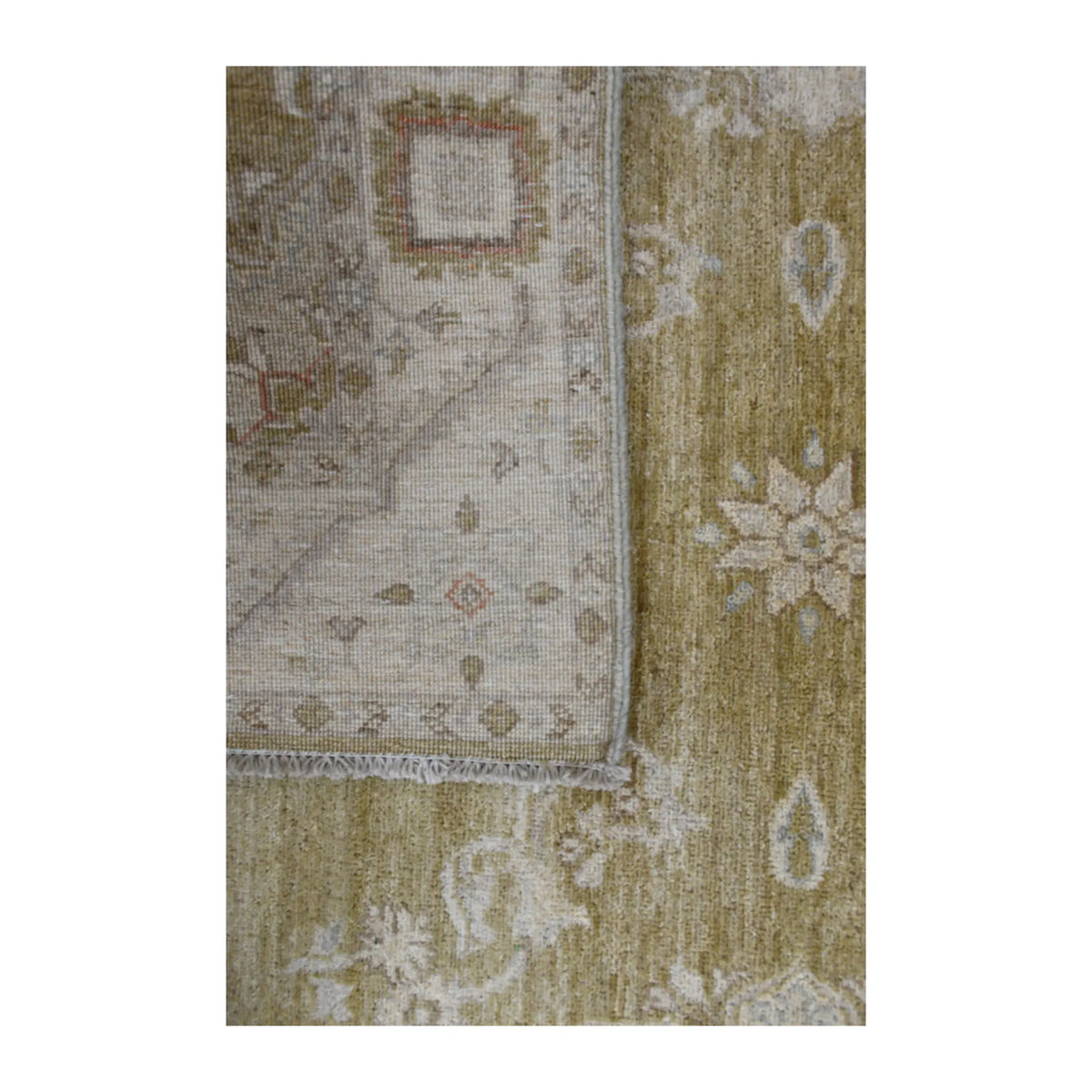 Folded-corner detail of Afghan Ziegler rug showing the reverse weave, olive-beige front and ivory floral motifs