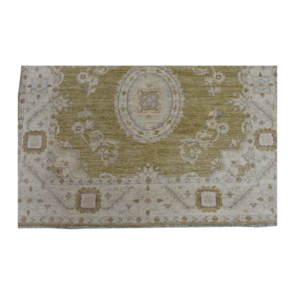 Fringe and end-border detail of Ziegler rug with an oval floral medallion, ivory framing and muted gold accents
