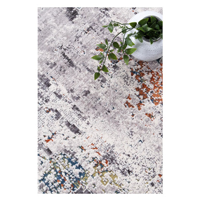 Styled close-up of Almeras A4 grey abstract rug with rust and blue-green accents
