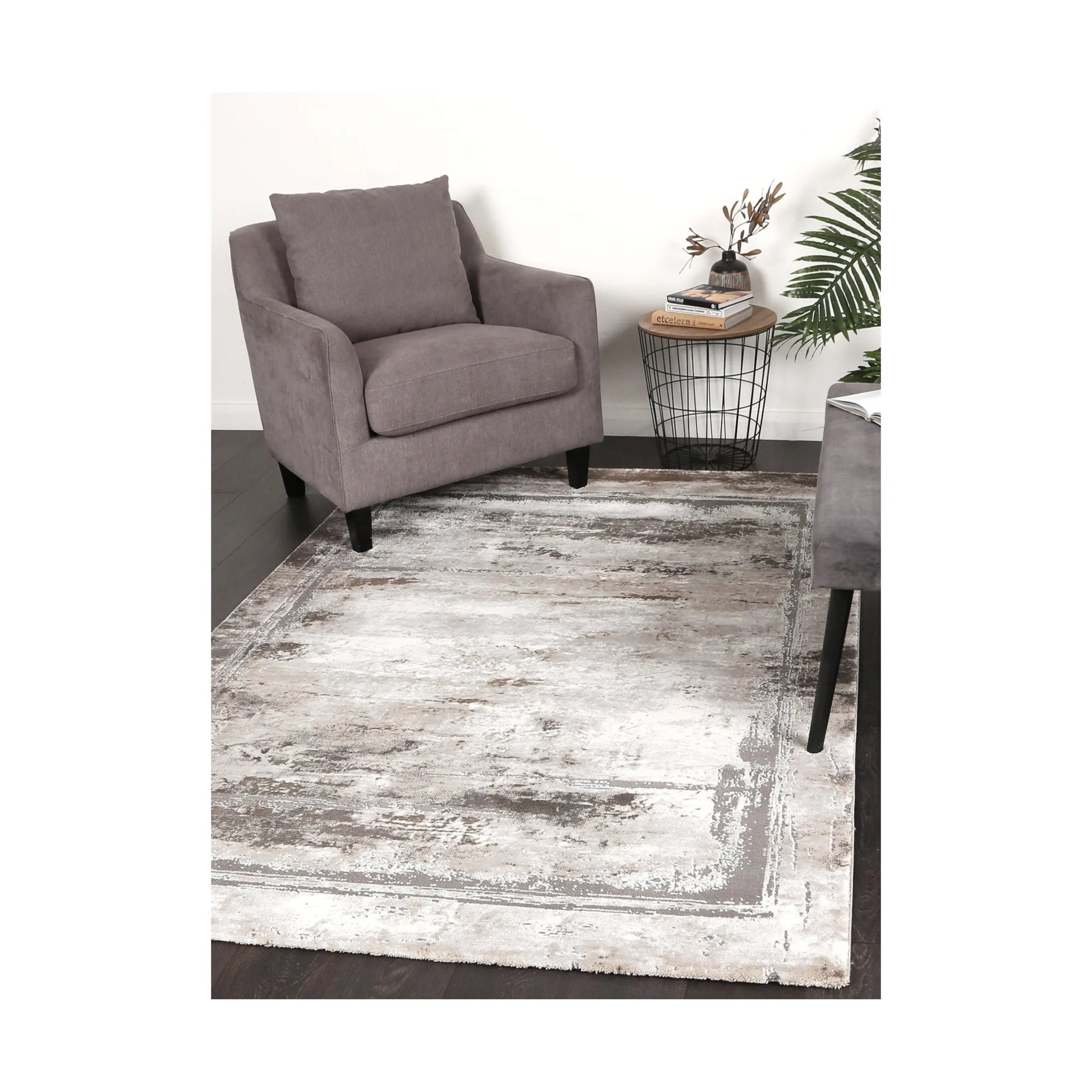 Antep 23314 975 Grey White modern rug styled with chair and indoor décor, showing soft neutral distressed pattern, 230 x 160 cm