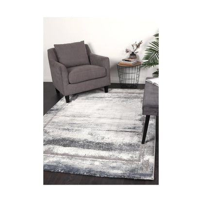 Antep 23314 Grey modern rug styled with chair and indoor décor, showing soft white grey tonal pattern, 230 x 160 cm