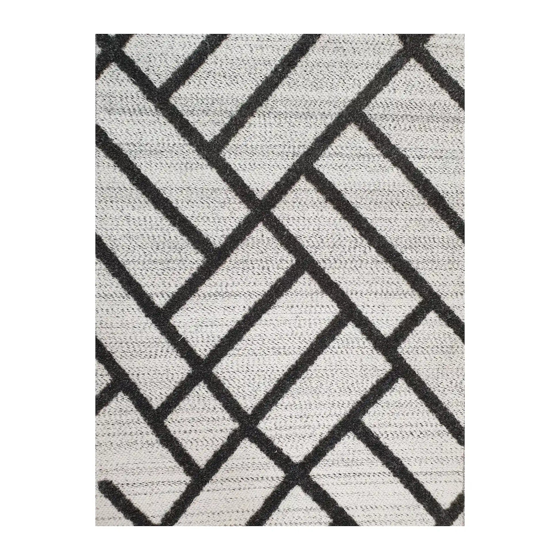 Close-up of Archer runner rug showing black linear geometric pattern on ivory polyester surface