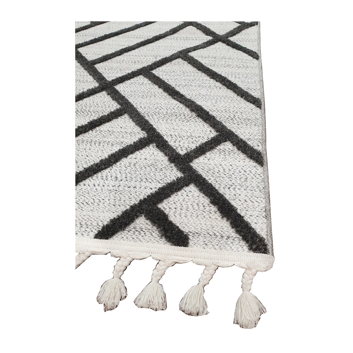 Tassel edge detail of Archer runner rug showing ivory textured surface and black geometric design