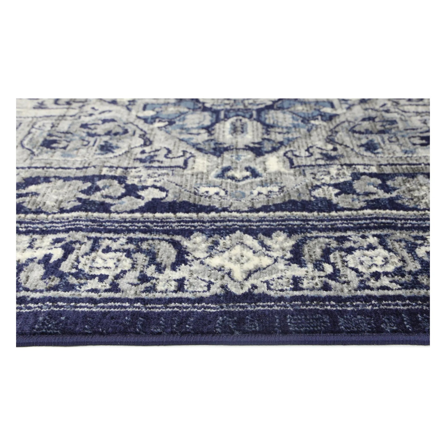 Border texture detail of Arya navy traditional rug showing ivory floral pattern
