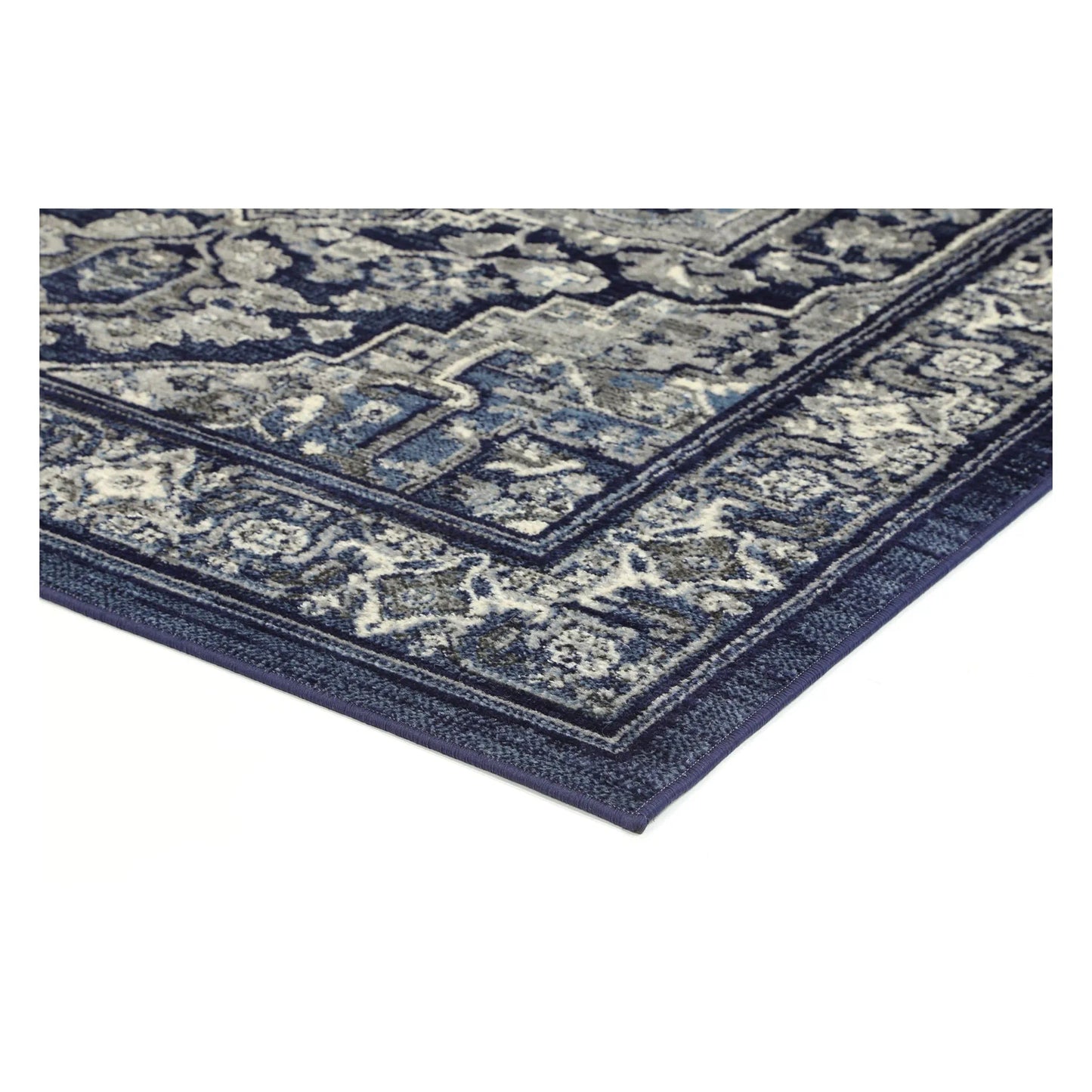 Corner detail of Arya navy rosette rug showing bound edge and pile texture