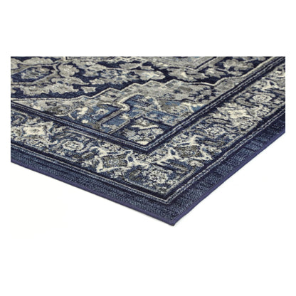Corner detail of Arya navy rosette rug showing bound edge and pile texture