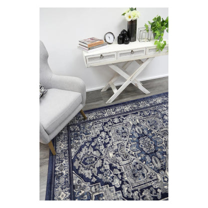 Angled lifestyle view of Arya navy rosette traditional rug showing full pattern layout