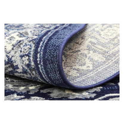 Rolled corner detail of Arya navy traditional rug showing flexible edge and texture