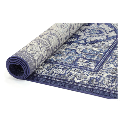 Rolled view of Arya navy traditional rug showing surface pattern and backing
