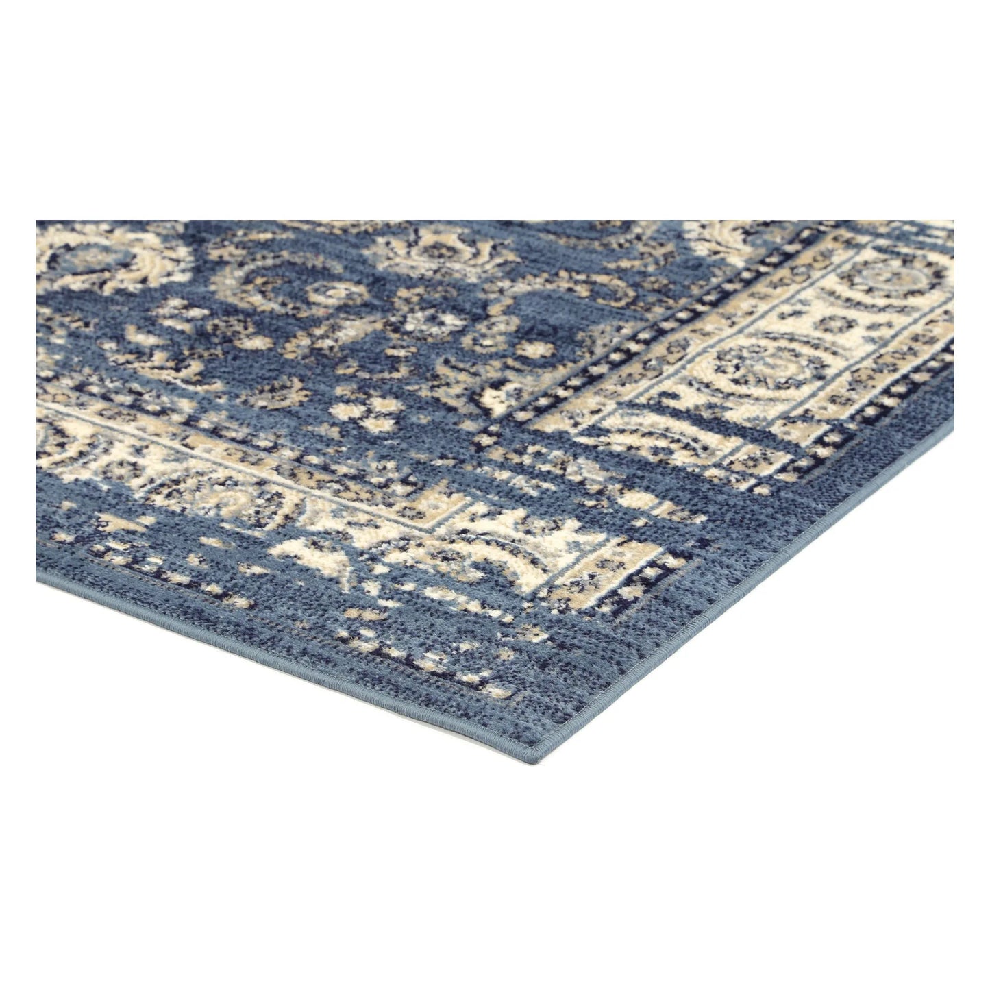 Corner detail of Arya blue traditional floral rug showing bound edge and pile texture