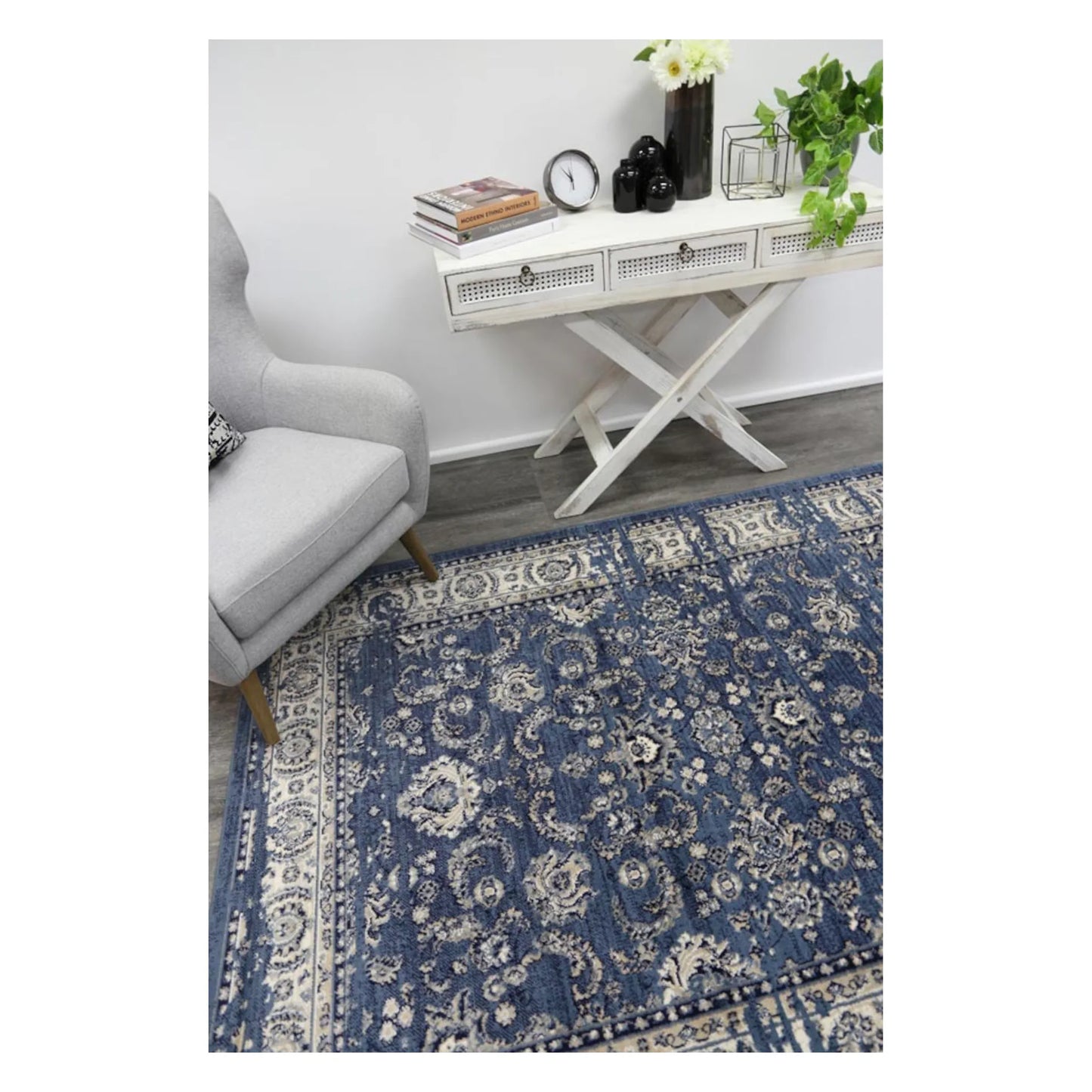 Angled lifestyle view of Arya blue traditional floral rug showing full pattern layout