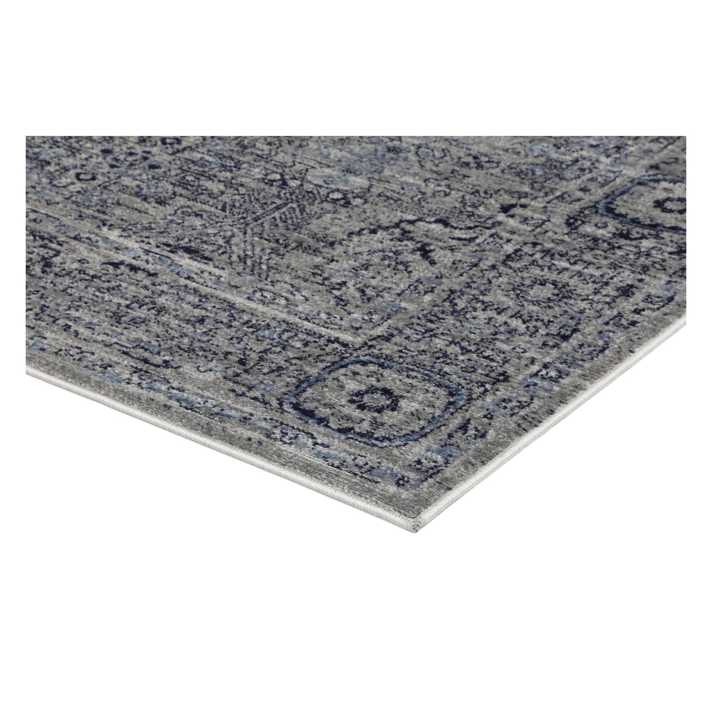 Corner detail of Arya charcoal traditional rug showing bound edge and pile texture