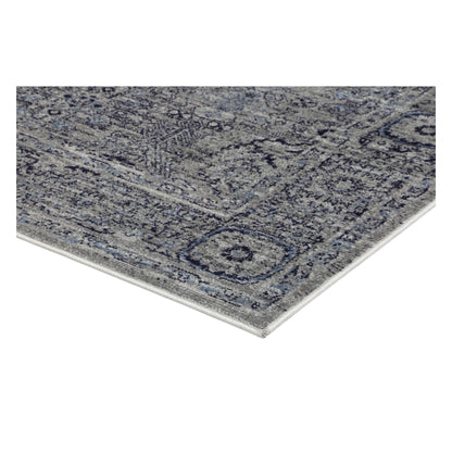Corner detail of Arya charcoal traditional rug showing bound edge and pile texture