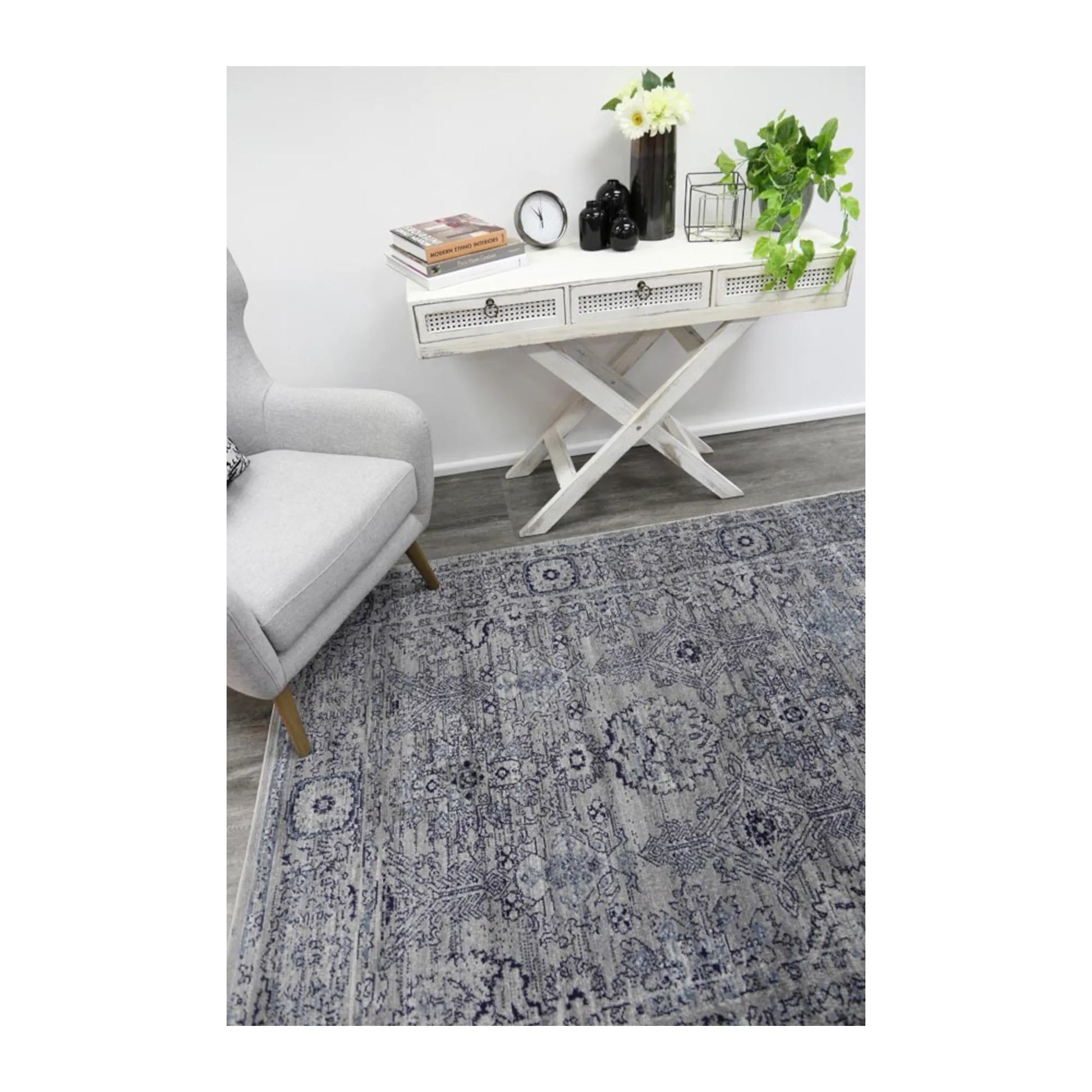 Angled lifestyle view of Arya charcoal traditional rug showing full pattern layout