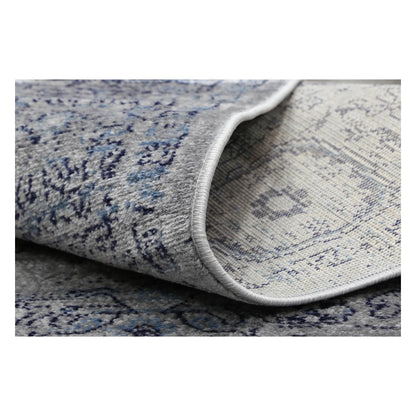 Rolled corner detail of Arya charcoal traditional rug showing flexible edge and texture