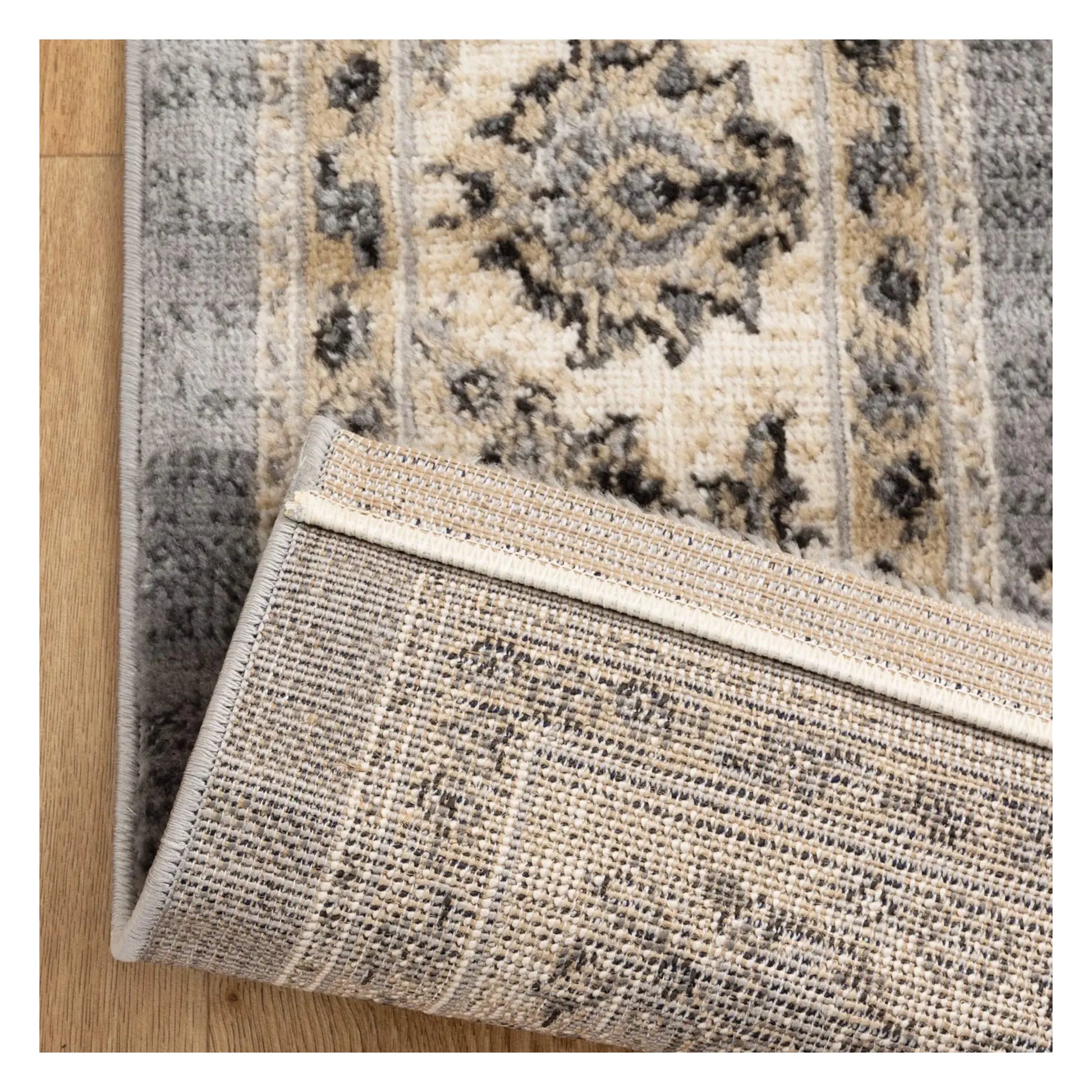 Backing detail of Arya grey traditional floral rug showing underside and woven surface