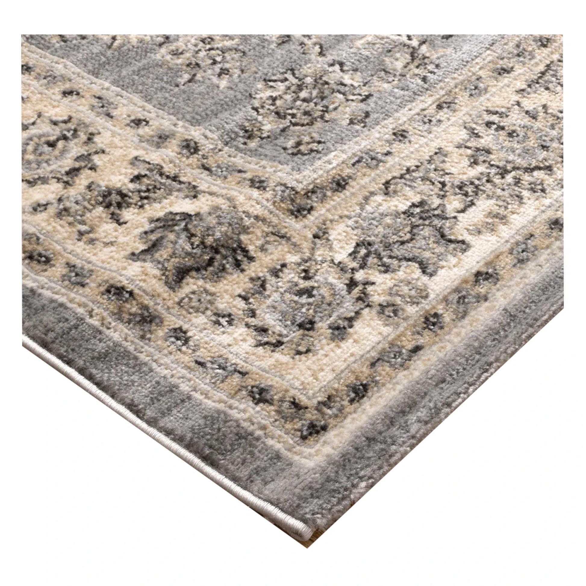 Corner texture detail of Arya grey traditional floral rug showing bound edge and pattern