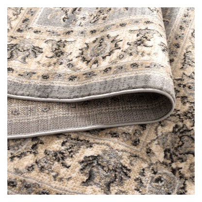 Folded edge detail of Arya grey traditional floral rug showing soft pile texture