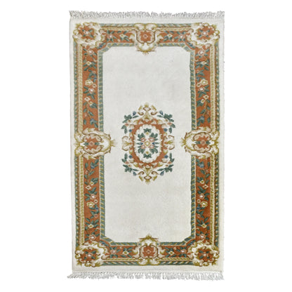 Full view of Aubusson hand-knotted wool rug with ivory field, oval floral medallion and ornate border, 180 x 92 cm