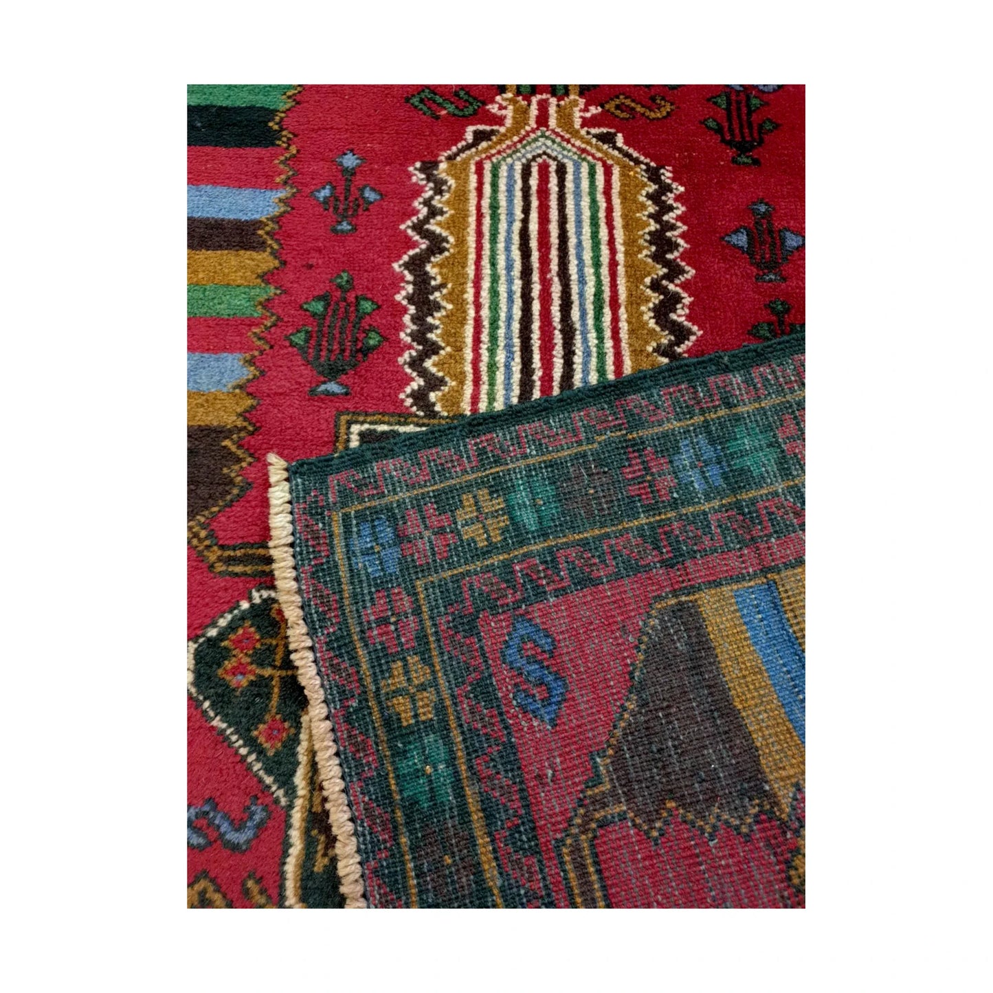 Baluchi fine hand-knotted wool rug folded corner detail