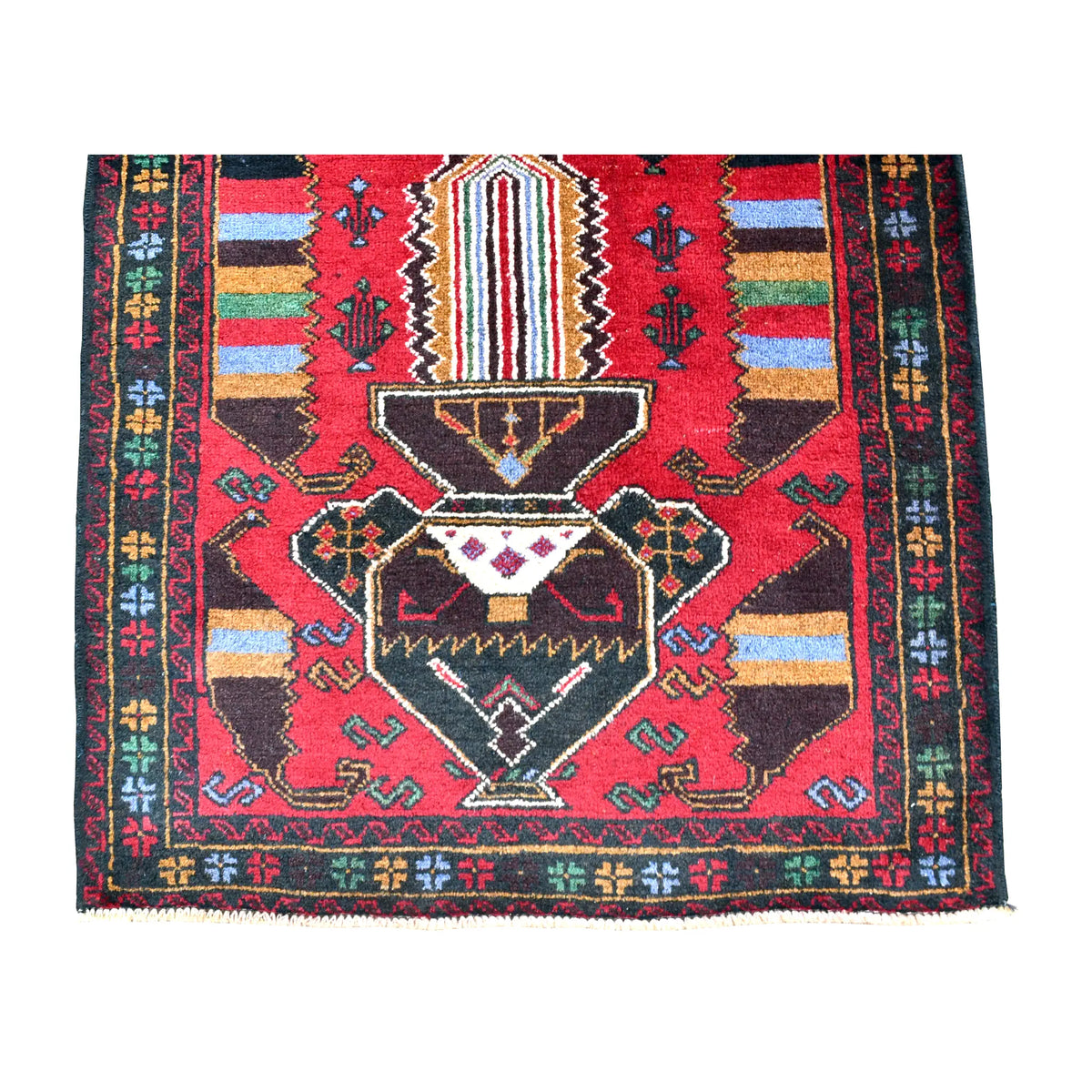 Fringe-end detail of Baluchi rug showing a dark angular medallion, striped panel, small hooked motifs and narrow borders