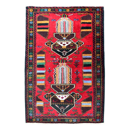 Full view of fine Baluchi wool rug with red field, two dark angular medallions and multicoloured striped panels, 145 x 84 cm