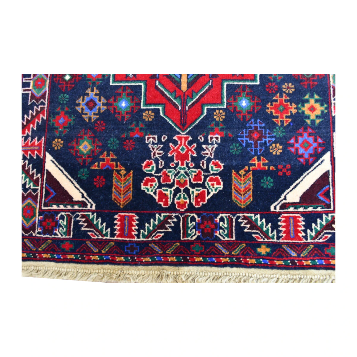End-field detail of Baluchi runner showing multicoloured floral motifs, angular corner forms and patterned border
