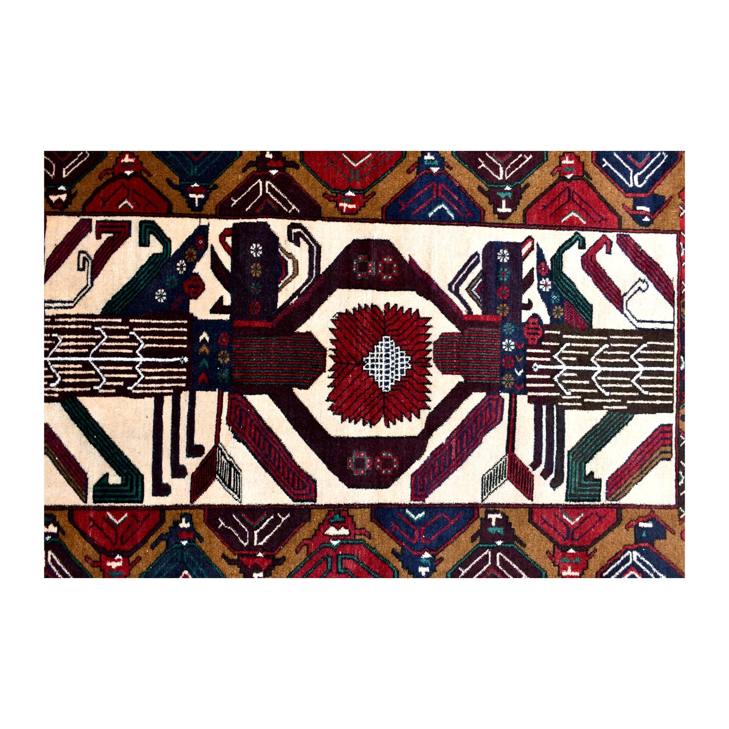 Field detail of Baluchi wool rug showing a geometric medallion and mirrored figurative motifs