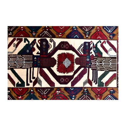 Field detail of Baluchi wool rug showing a geometric medallion and mirrored figurative motifs