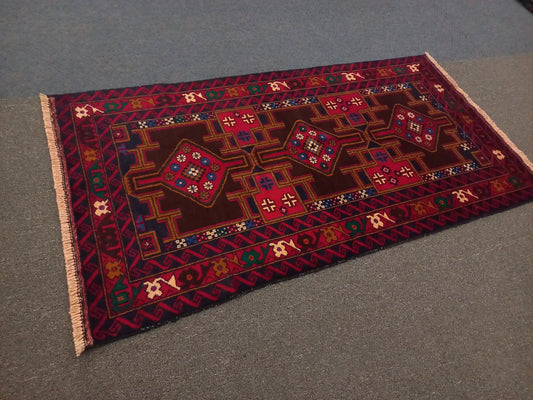 Baluchi hand-knotted wool rug 190 x 102 cm angled view