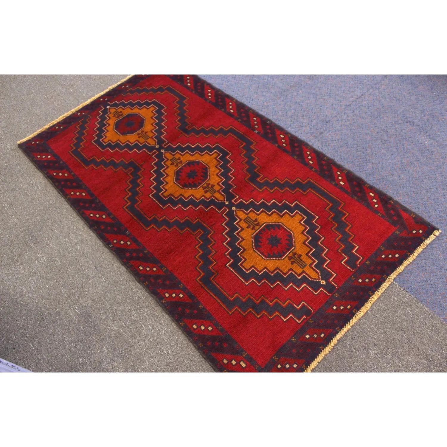 Baluchi hand-knotted wool rug 194 x 115 cm angled view