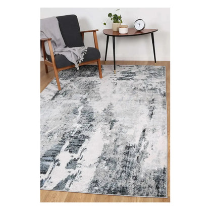 Bergen blue and grey abstract rug styled with armchair and side table