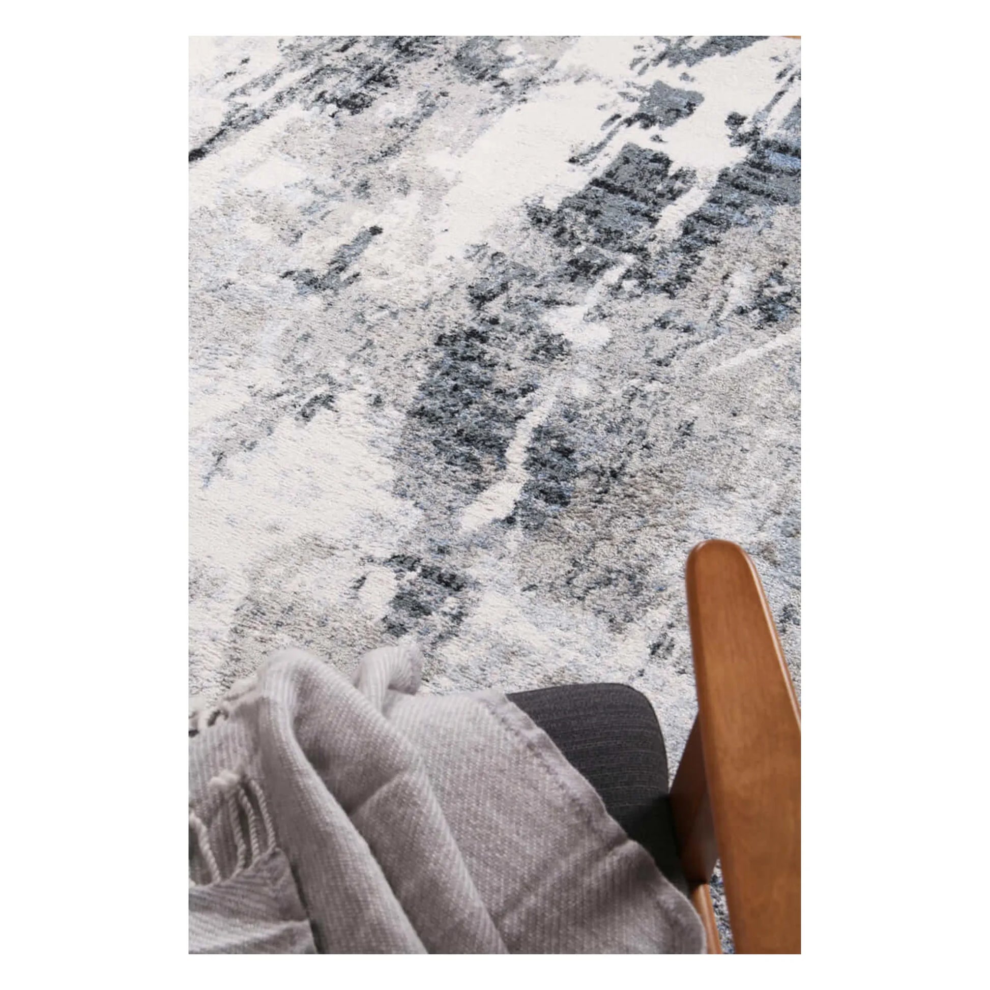 Styled close-up of Bergen blue and grey abstract rug showing soft surface texture