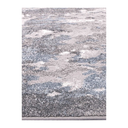 Angled full view of Bergen grey blue abstract rug showing abstract surface design