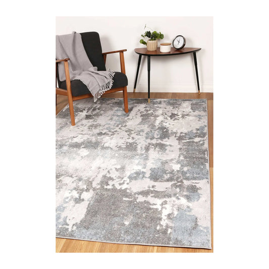 Bergen grey blue abstract modern rug styled with grey armchair and side table
