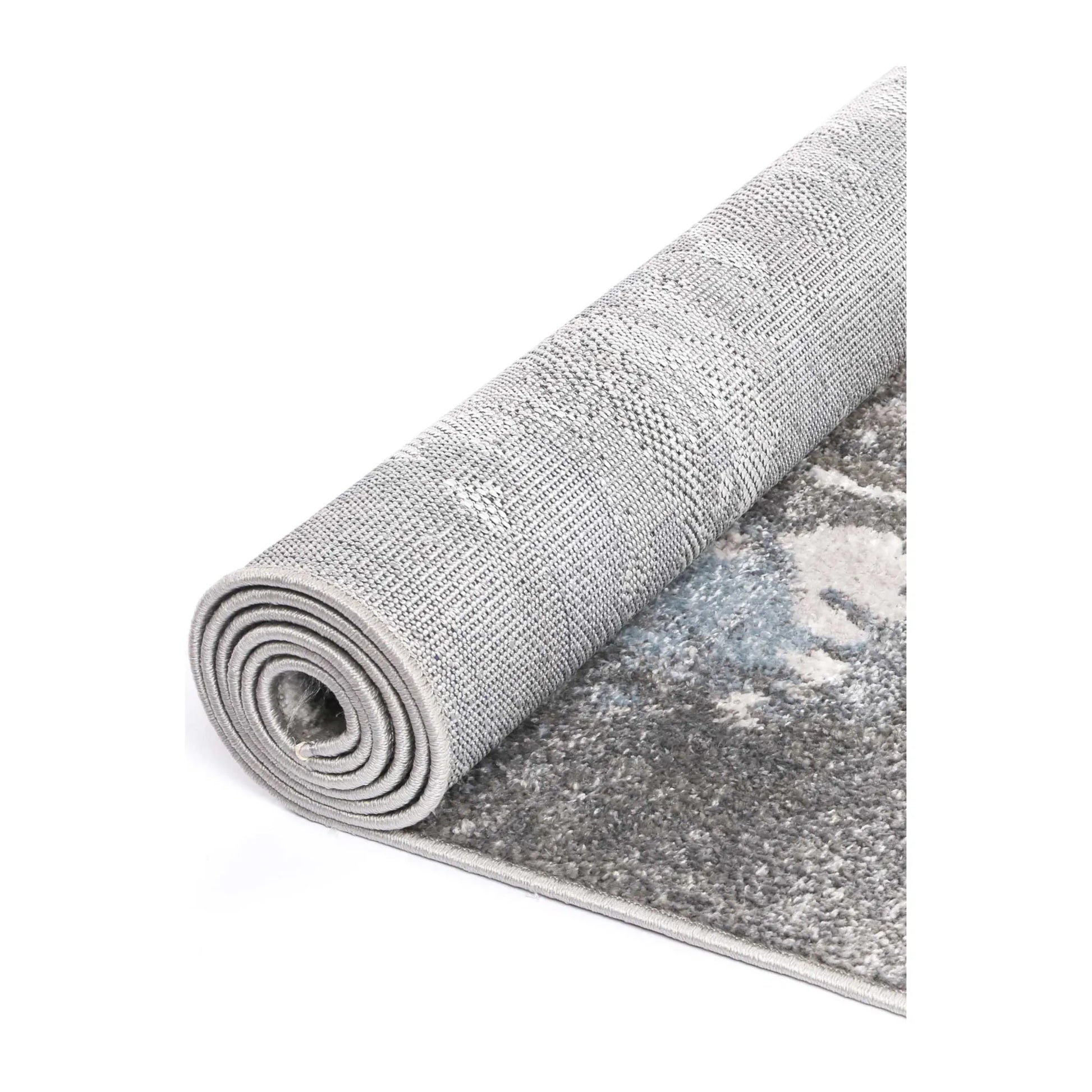 Rolled view of Bergen grey blue abstract modern rug showing surface texture and backing
