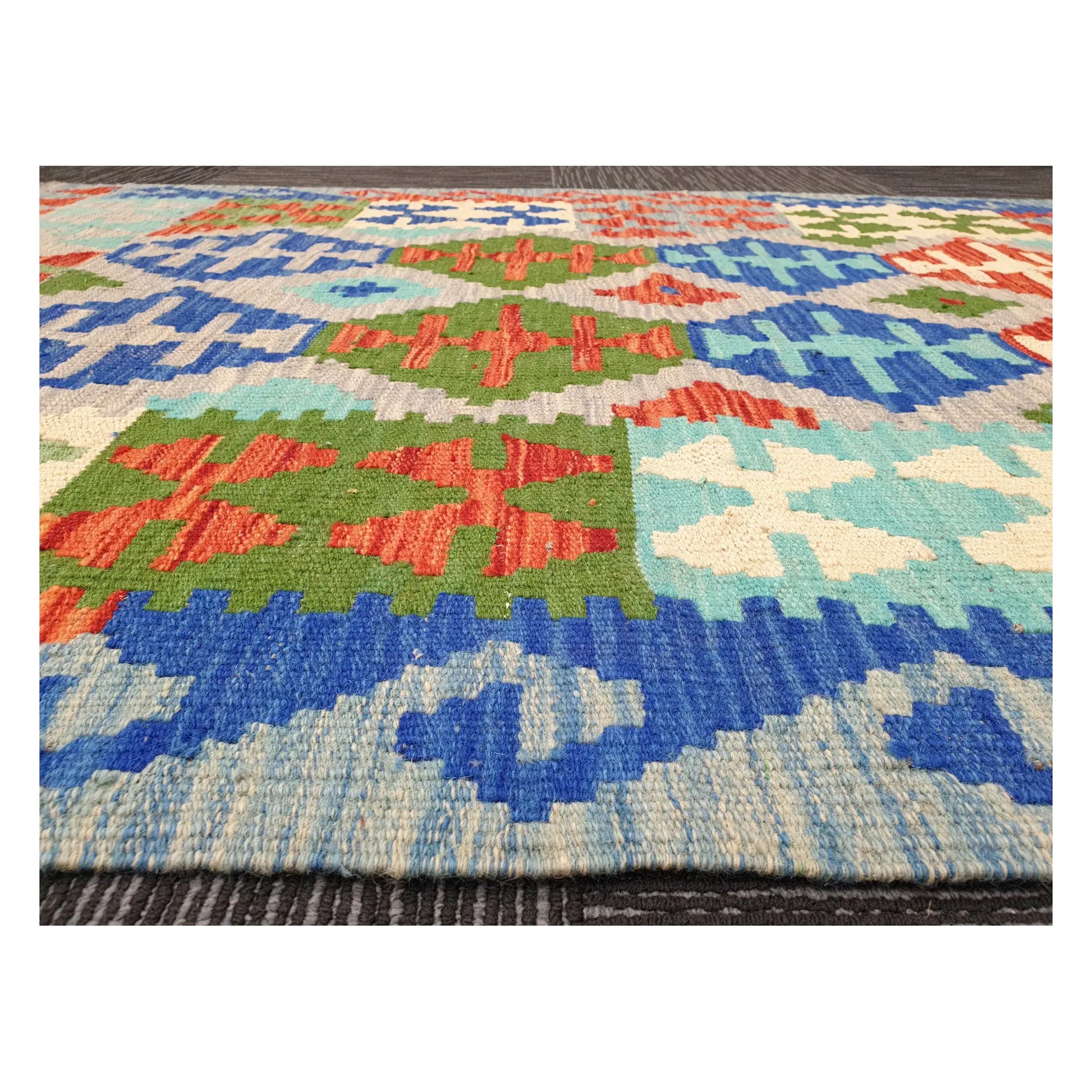 Low-angle close-up of Afghan Chobi Kilim showing wool flatweave texture and multicolour geometric pattern, 144 x 105 cm
