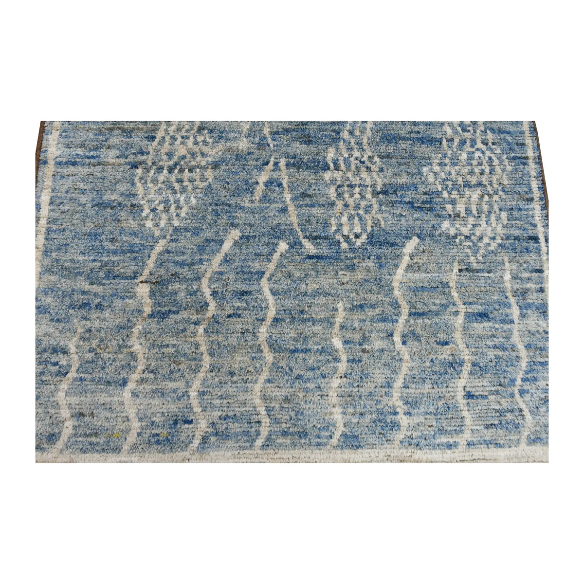 Pattern detail of the tonal blue field with raised ivory abstract motifs and pale border