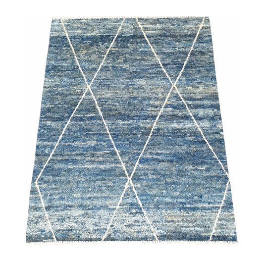 Angled view of blue Moroccan wool rug with open ivory diamond pattern, 180 x 140 cm