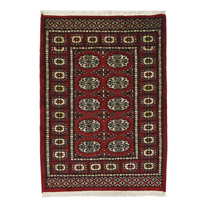 Full view of Bokhara hand-knotted wool rug with red field and repeated oval gul-style motifs, 115 x 82 cm