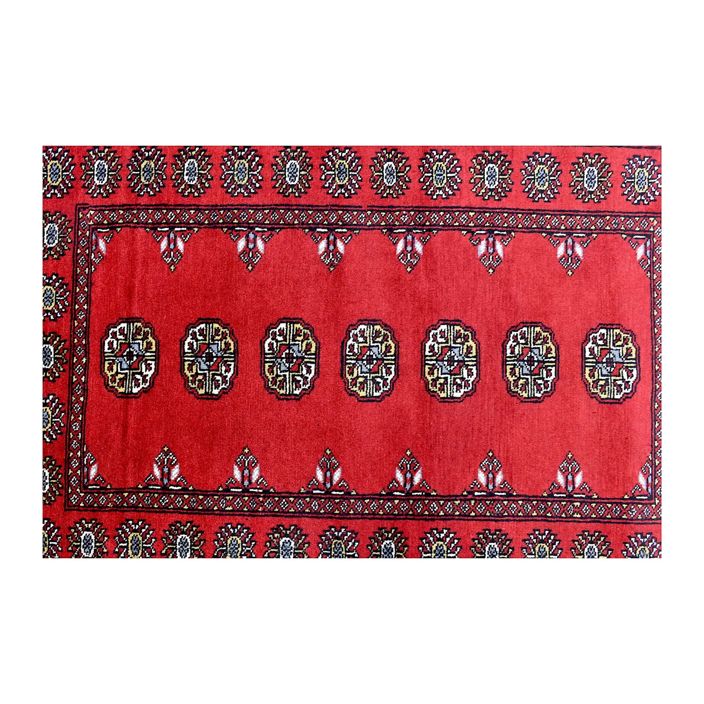 Length field detail of Bokhara wool rug showing repeated oval gul-style motifs with black and ivory accents