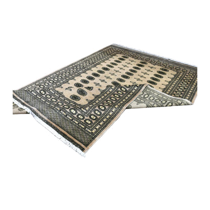 Folded view of Bokhara wool rug showing its ivory gul field, layered borders and pale reverse