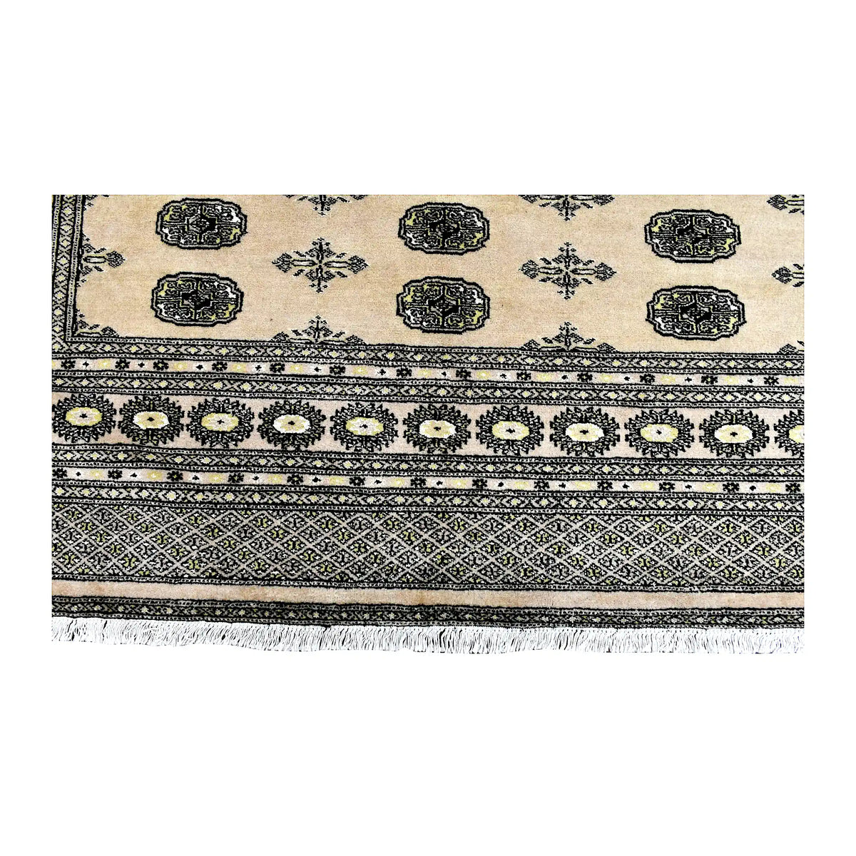 Fringe-end detail of Bokhara rug showing oval guls, a rosette band, diamond-lattice borders and white fringe